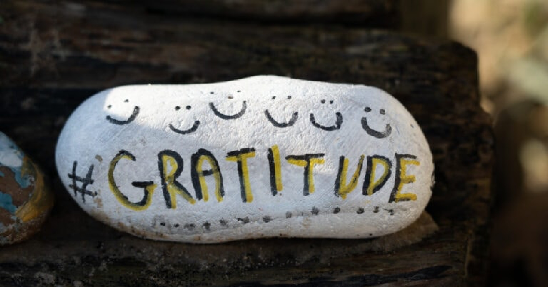 Rock with smiles and written word "Gratitude"