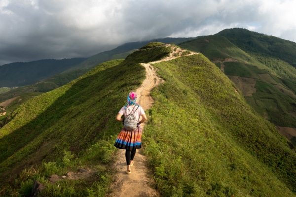 self care photo shows hiker walking along a mountain ridge